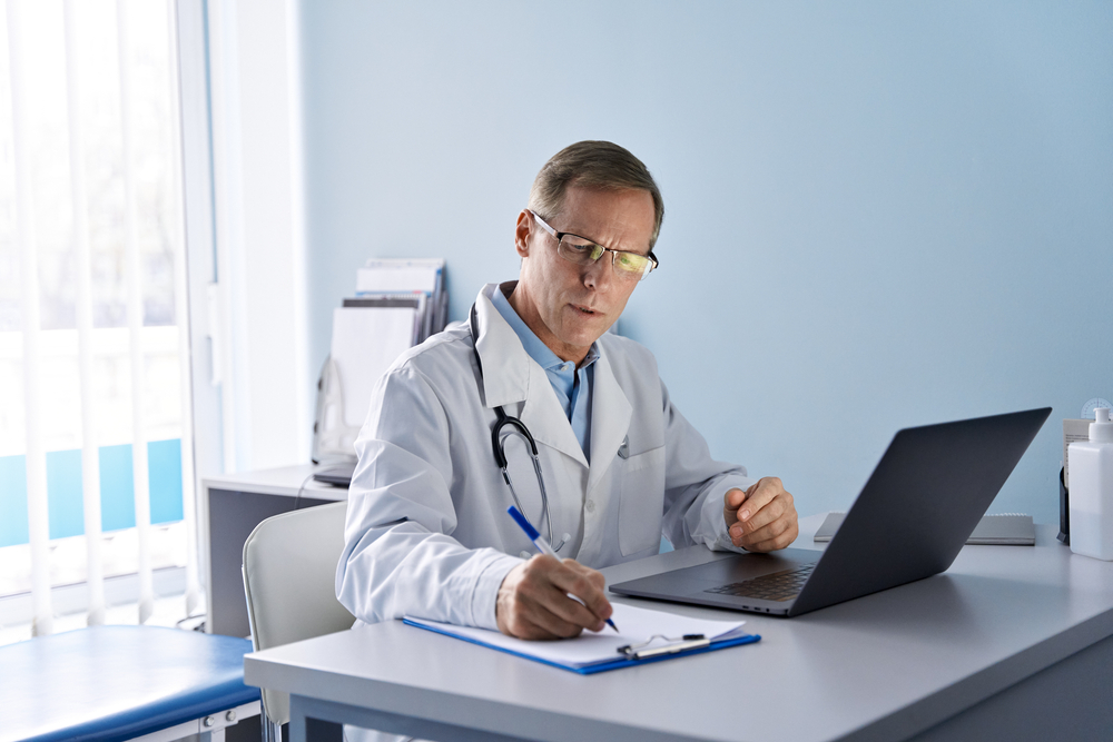 Serious,Old,Mature,Professional,Male,Doctor,Using,Laptop,Computer,In Serious,Old,Mature,Professional,Male,Doctor,Using,Laptop,Computer,In